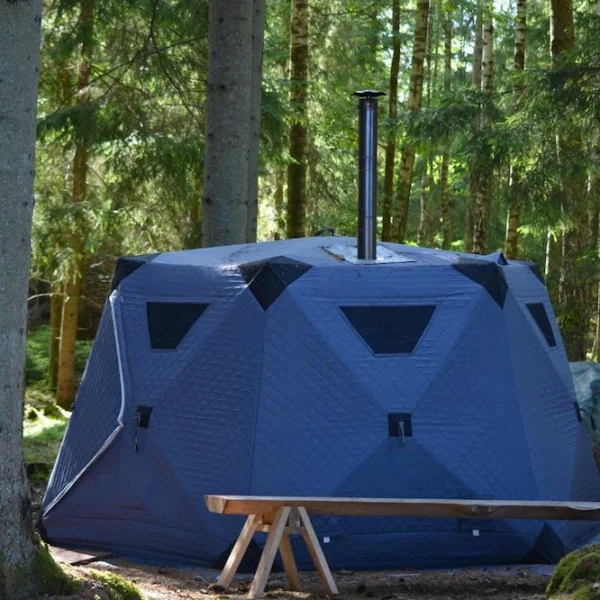 A wood‑fired sauna tent set up by Lake Mjörn — a nature‑immersed experience with Pevon Ecotourism.